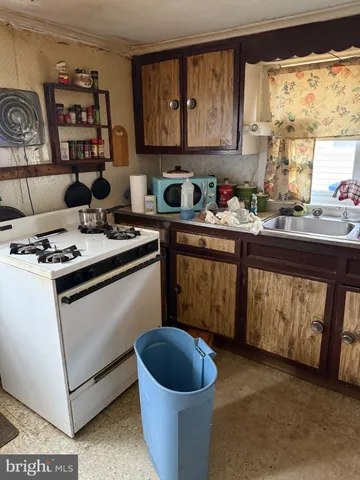 a kitchen with a stove a sink and a refrigerator