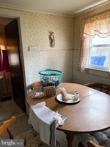 a dining room with furniture and window