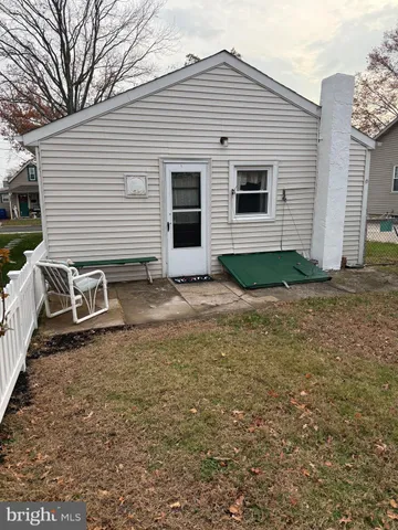 a view of a small house with a yard