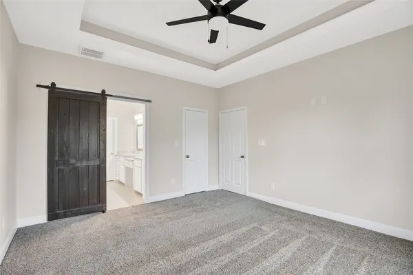 an empty room with a window and a ceiling fan