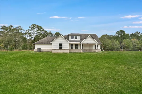 a view of house with garden and deck