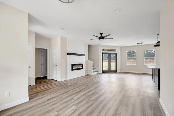 a view of a livingroom with wooden floor and a ceiling fan