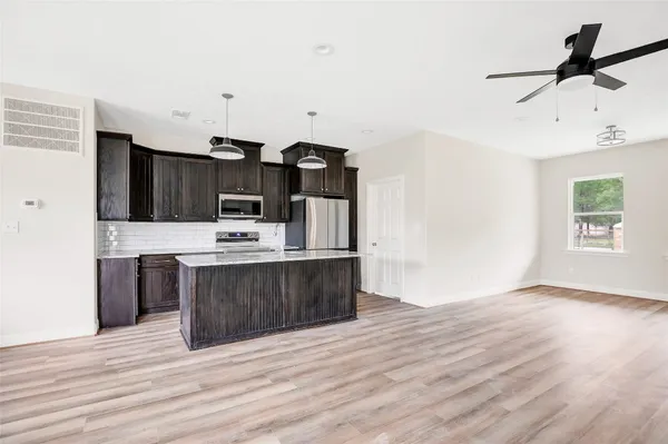a kitchen with stainless steel appliances a sink and a refrigerator