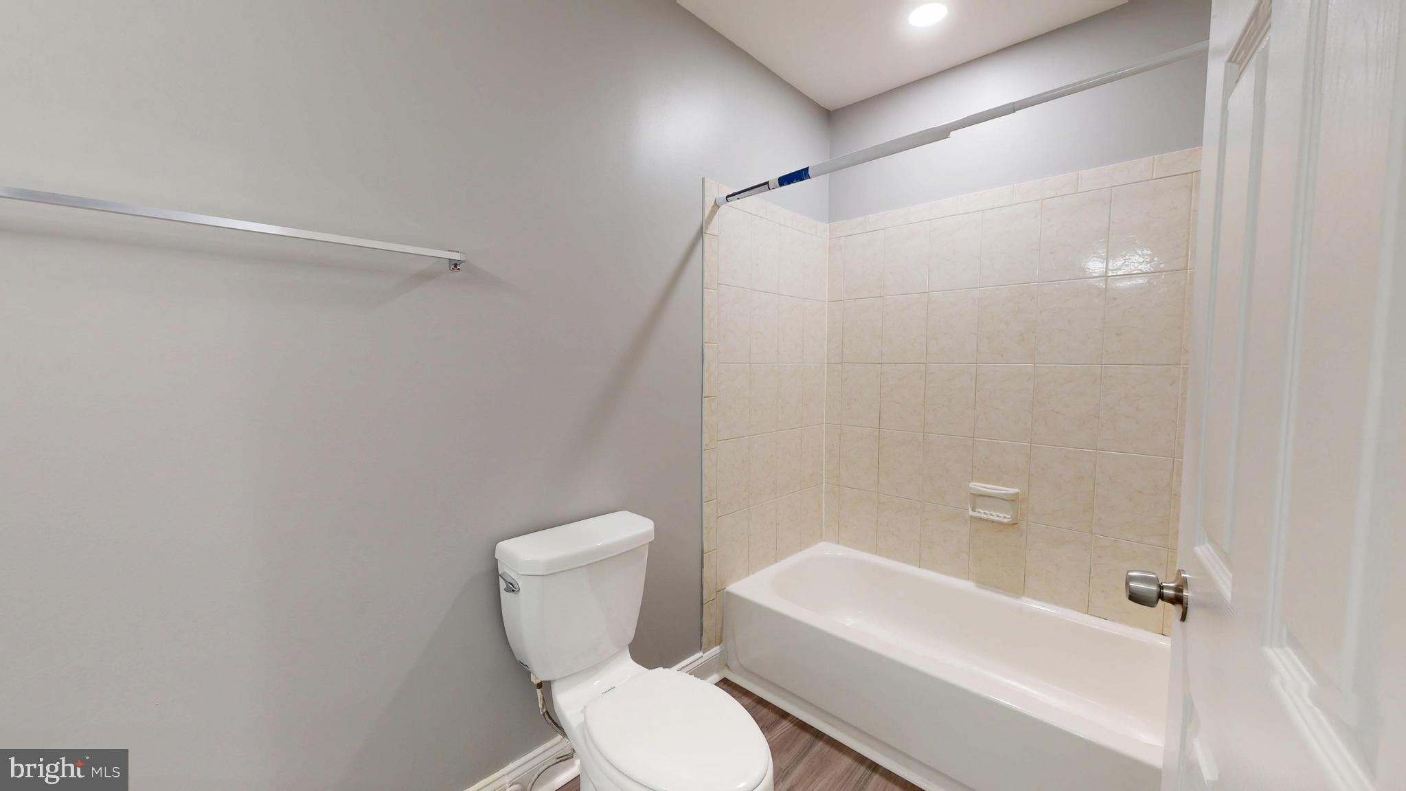 1824 Federal Street Baltimore, MD 21213 - Photo 11 of 17 a white toilet sitting next to a bath tub