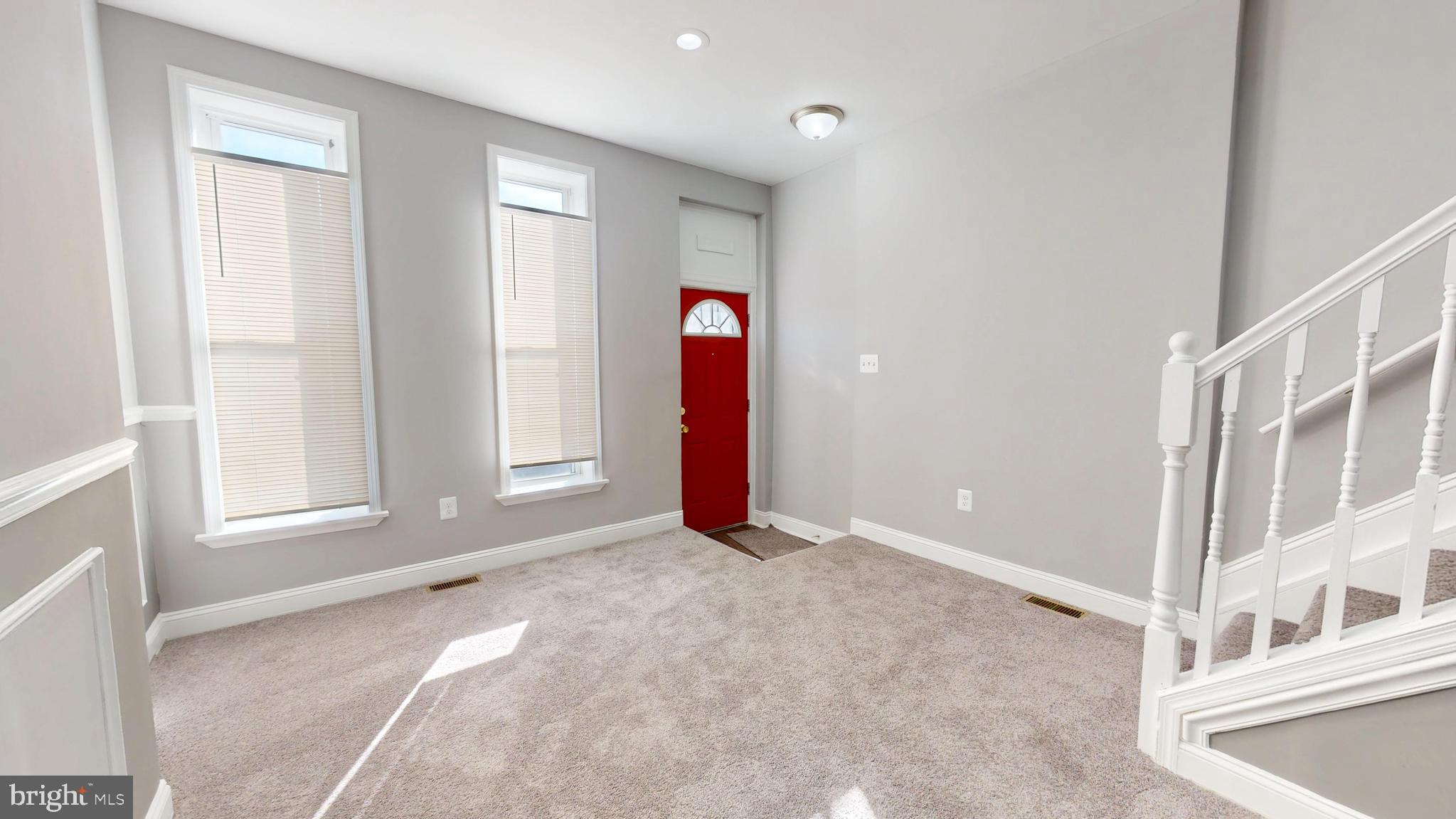 1824 Federal Street Baltimore, MD 21213 - Photo 2 of 17 a view of an empty room with wooden floor and entryway