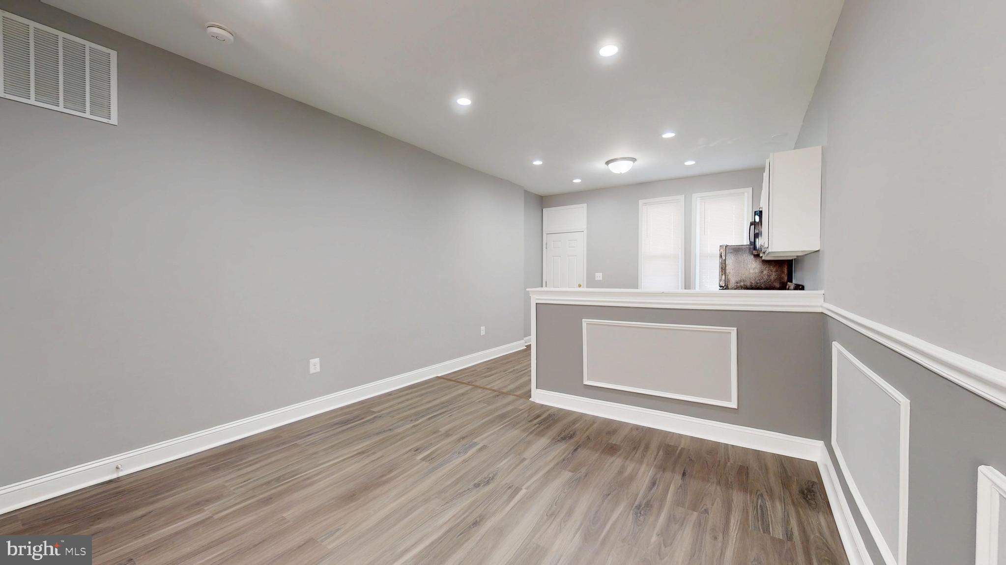 1824 Federal Street Baltimore, MD 21213 - Photo 5 of 17 a kitchen with a sink and dishwasher with wooden floor