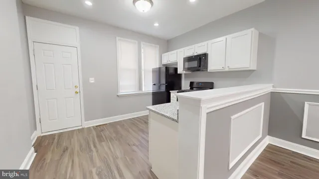 a view of a kitchen with electric appliances