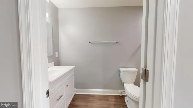 a bathroom with a sink a toilet a shower and a window