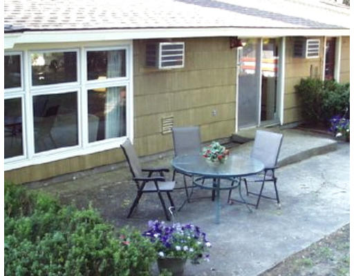 46 Joseph Road Framingham, MA 01701 - Photo 2 of 6 a backyard of a house with table and chairs