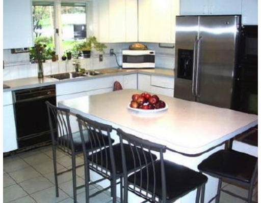 46 Joseph Road Framingham, MA 01701 - Photo 4 of 6 a kitchen with a table and chairs