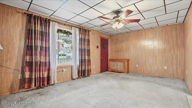 a kitchen with a table chairs refrigerator and window