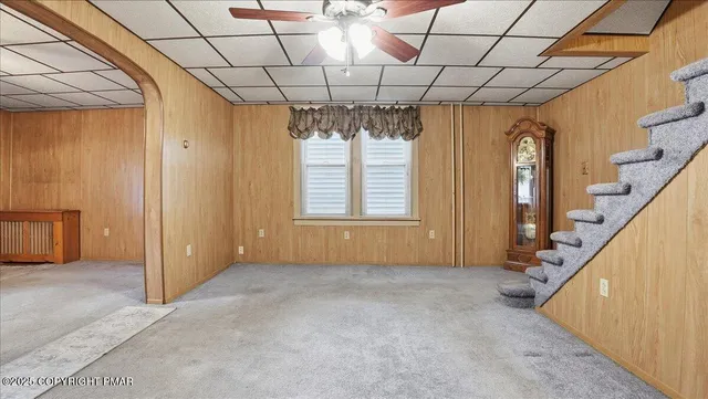 a kitchen with a table chairs refrigerator and cabinets