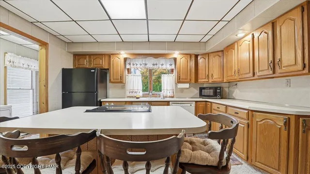 a kitchen with a refrigerator and a sink