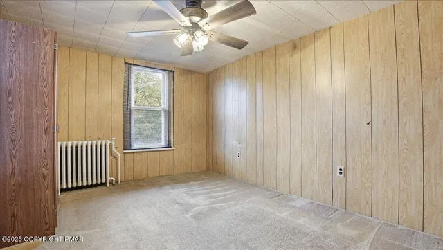 a white toilet sitting next to a bath tub and a shower