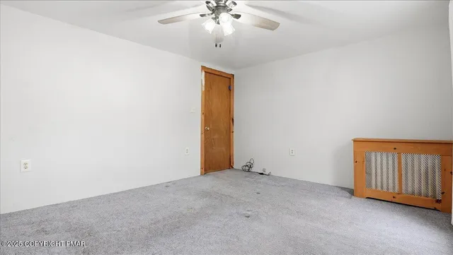 a view of an empty room with a chandelier