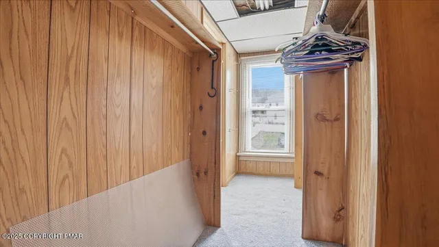a view of empty room with wooden ceiling