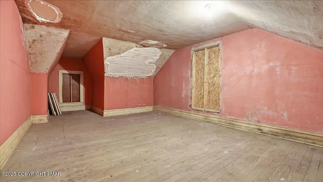 a view of a house with wooden deck and furniture