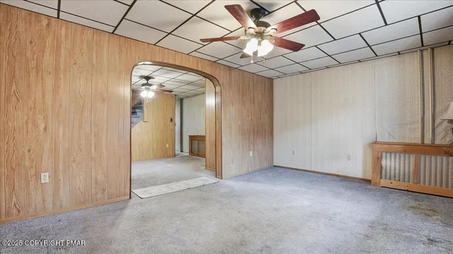 an aerial view of residential houses with outdoor space and parking