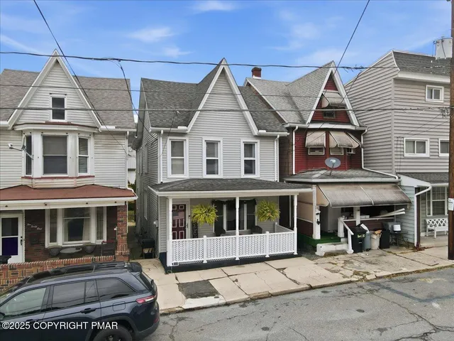 a front view of a residential apartment building with a yard