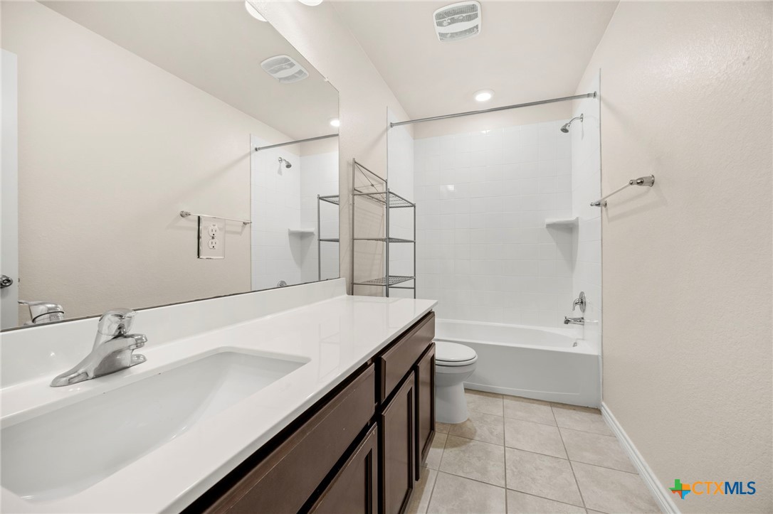 5927 Galveston Road Belton, TX 76513 - Photo 34 of 39 a bathroom with a sink double vanity granite tub shower and a mirror
