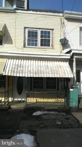 a view of a backyard with basket ball court and outdoor seating