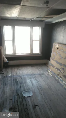 a room with wooden floor and shoes