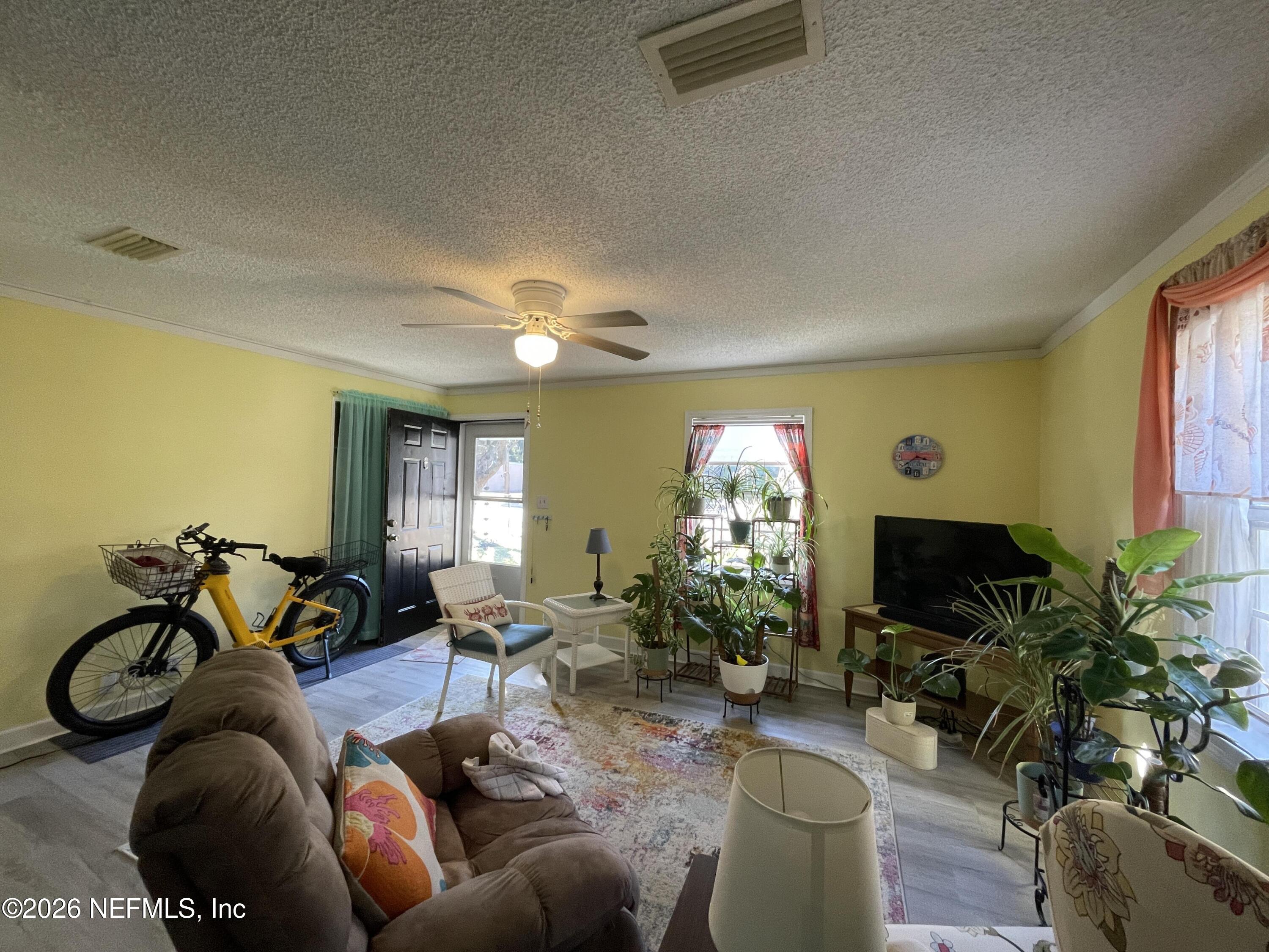 709 North 11th Street Palatka, FL 32177 - Photo 9 of 33 a living room with furniture and a potted plant