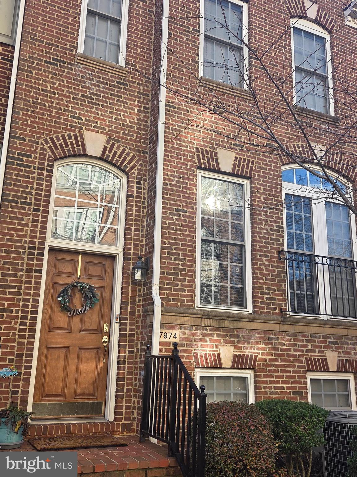 7974 Vigne Court Vienna, VA 22182 - Photo 2 of 2 a front view of a brick house with a door