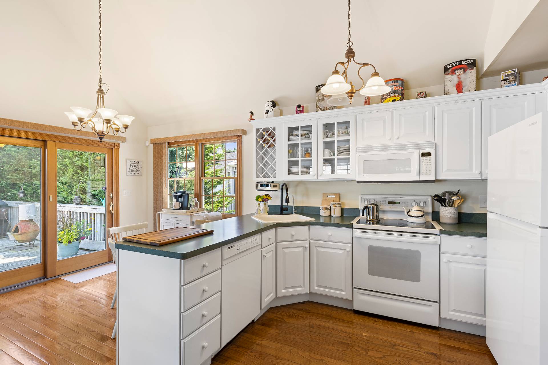 Undisclosed Address Remsenburg, NY 11960 - Photo 27 of 41 a kitchen that has a lot of white cabinets and wooden floor