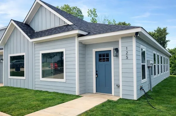 a front view of a house with a yard
