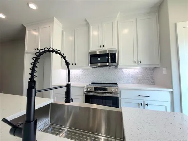 a kitchen with kitchen island a stove and a refrigerator