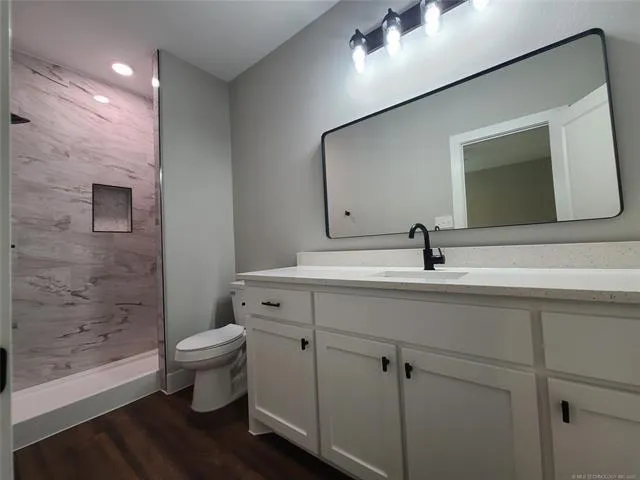 a bathroom with a toilet sink and mirror