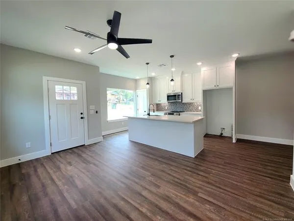 a kitchen with stainless steel appliances granite countertop a dishwasher a stove and a refrigerator