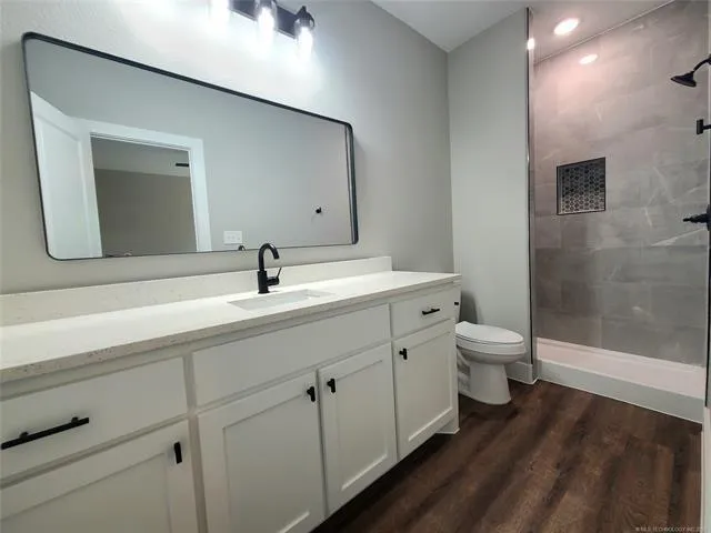 a spacious bathroom with a toilet sink and shower