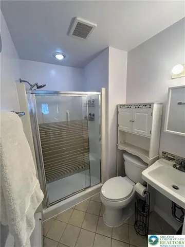 a bathroom with a toilet a sink and shower