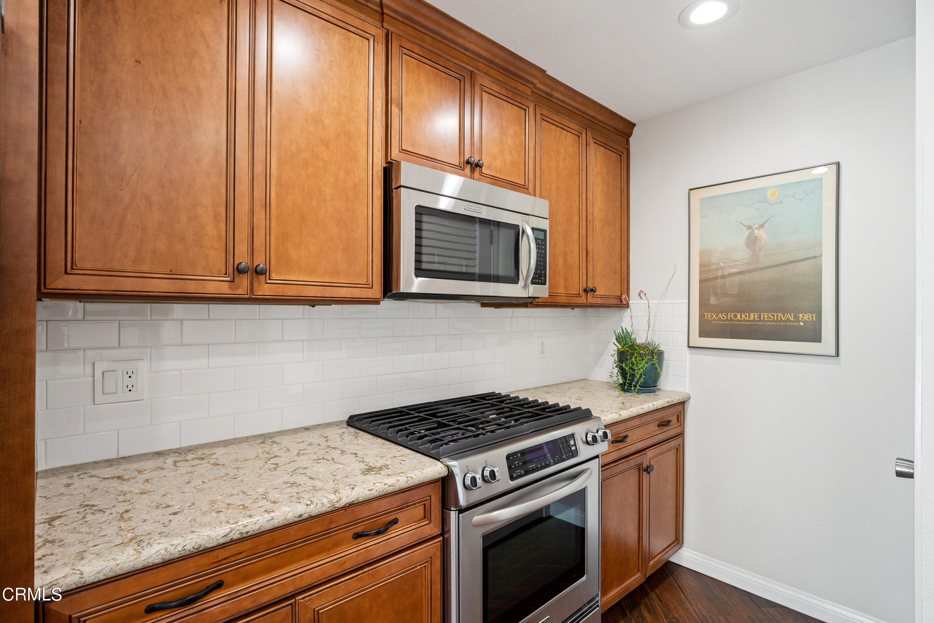 2263 Martinique Lane Oxnard, CA 93035 - Photo 12 of 38 a kitchen with granite countertop cabinets stainless steel appliances and wooden floor