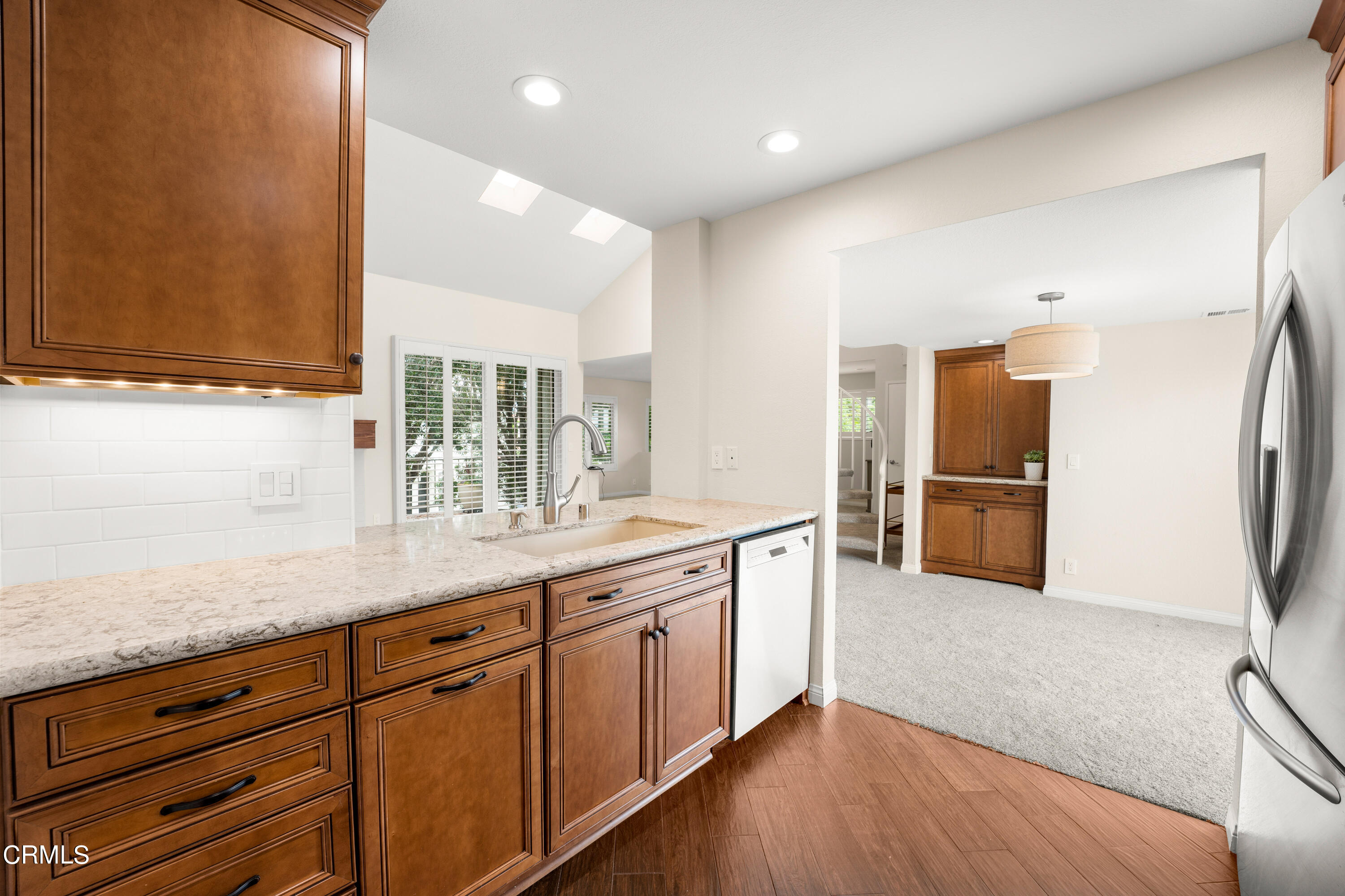2263 Martinique Lane Oxnard, CA 93035 - Photo 10 of 38 a kitchen with stainless steel appliances granite countertop a sink and a refrigerator