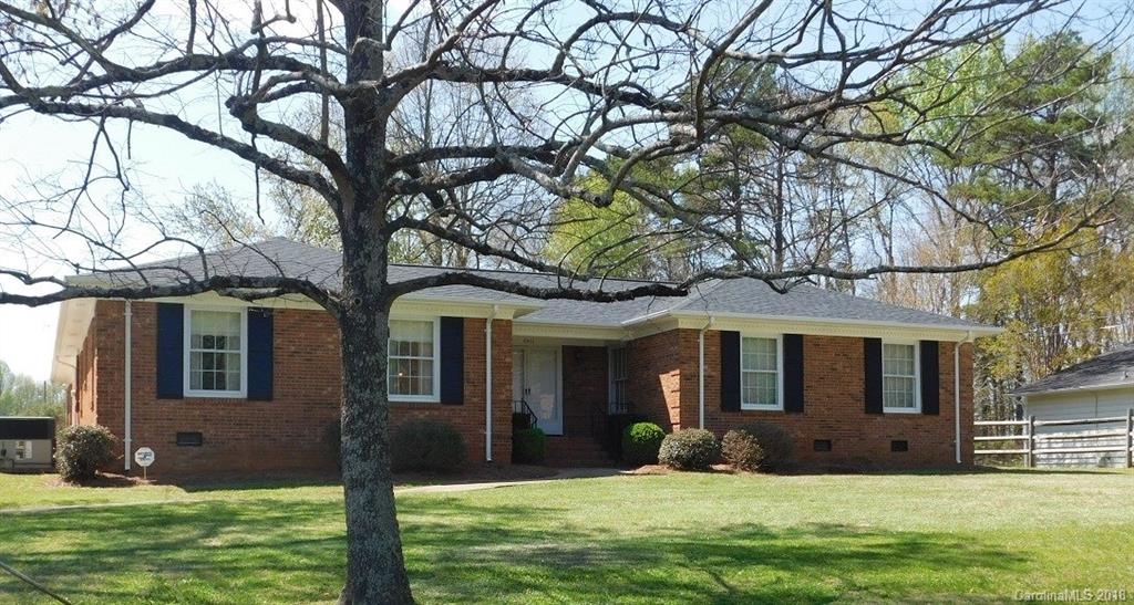 6311 Lake Forest Road East Charlotte, NC 28227 - Photo 2 of 31 a view of a yard in front of a house with large tree