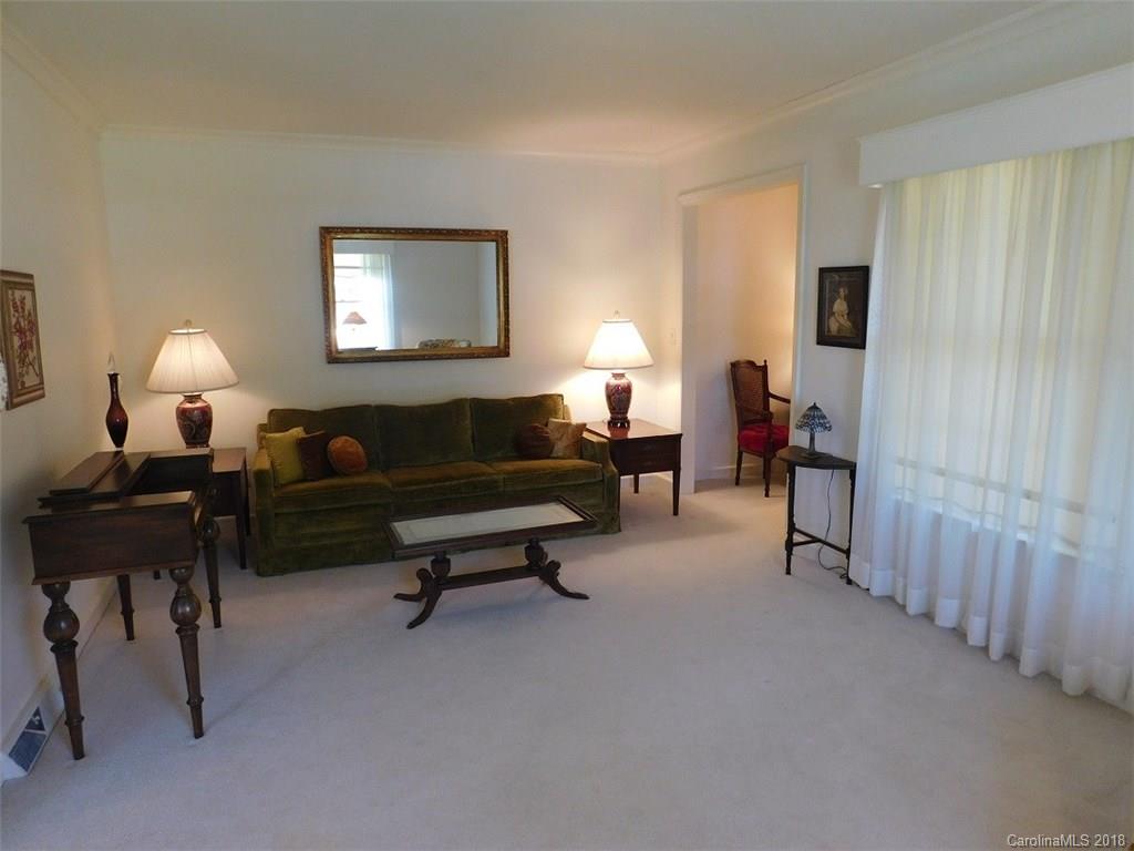 6311 Lake Forest Road East Charlotte, NC 28227 - Photo 11 of 31 a living room with furniture and a lamp