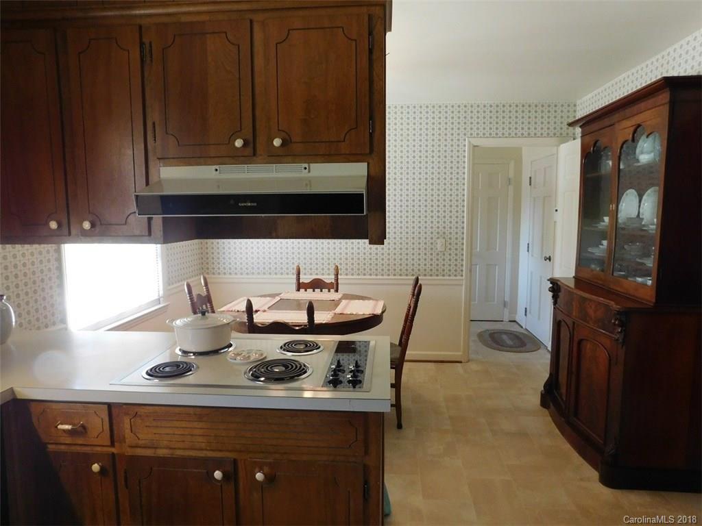 6311 Lake Forest Road East Charlotte, NC 28227 - Photo 15 of 31 a kitchen with a stove a sink and a microwave