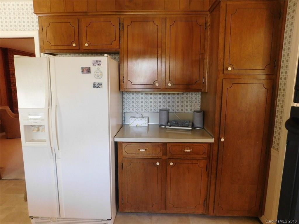6311 Lake Forest Road East Charlotte, NC 28227 - Photo 16 of 31 a kitchen with a refrigerator and cabinets