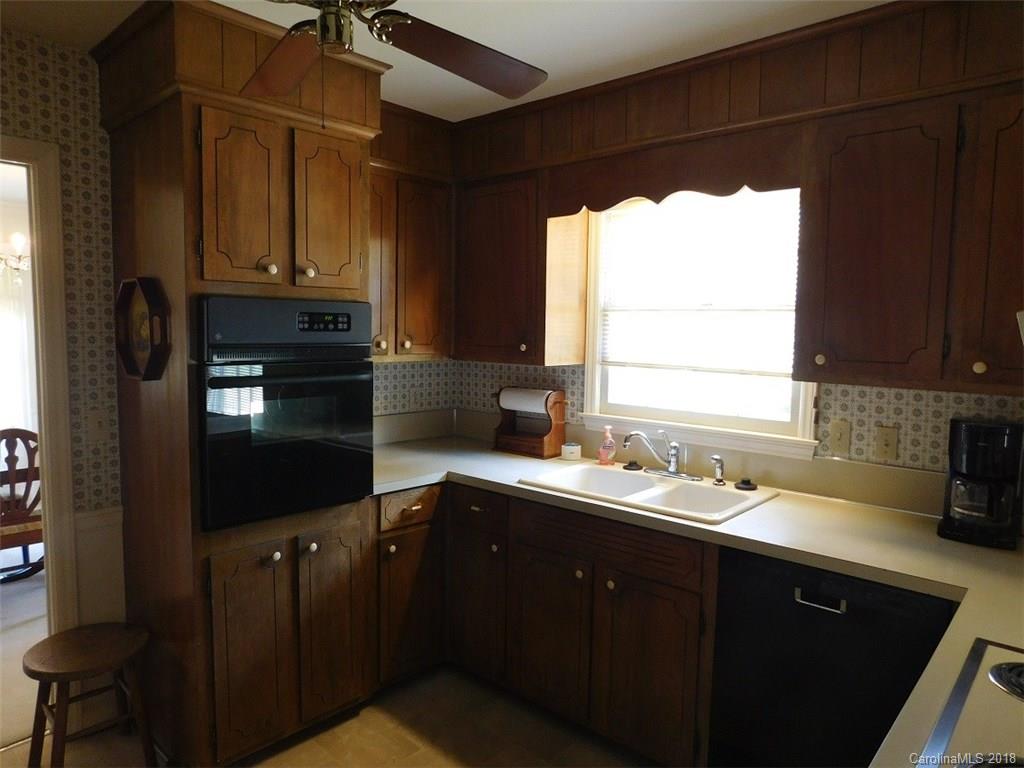 6311 Lake Forest Road East Charlotte, NC 28227 - Photo 17 of 31 a kitchen with a sink a window and cabinets