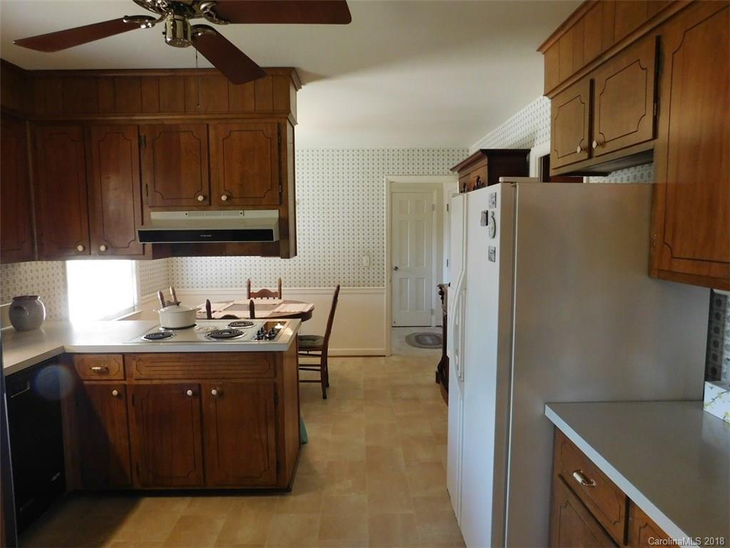 6311 Lake Forest Road East Charlotte, NC 28227 - Photo 18 of 31 a kitchen with stainless steel appliances granite countertop a refrigerator and a sink