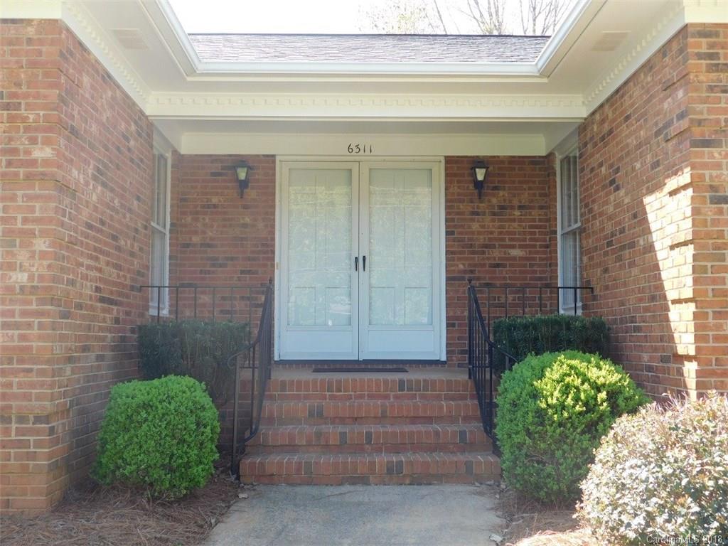 6311 Lake Forest Road East Charlotte, NC 28227 - Photo 3 of 31 a front view of a house with a garden