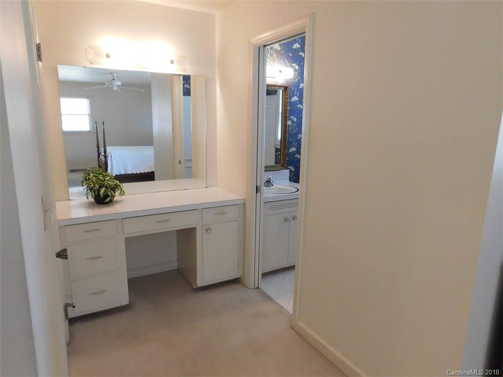 6311 Lake Forest Road East Charlotte, NC 28227 - Photo 22 of 31 a bathroom with a sink and a mirror