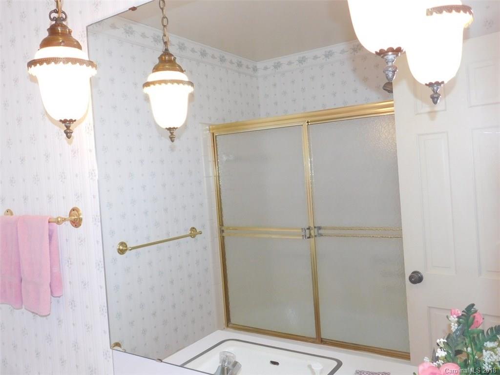 6311 Lake Forest Road East Charlotte, NC 28227 - Photo 23 of 31 a bathroom with a shower and a window