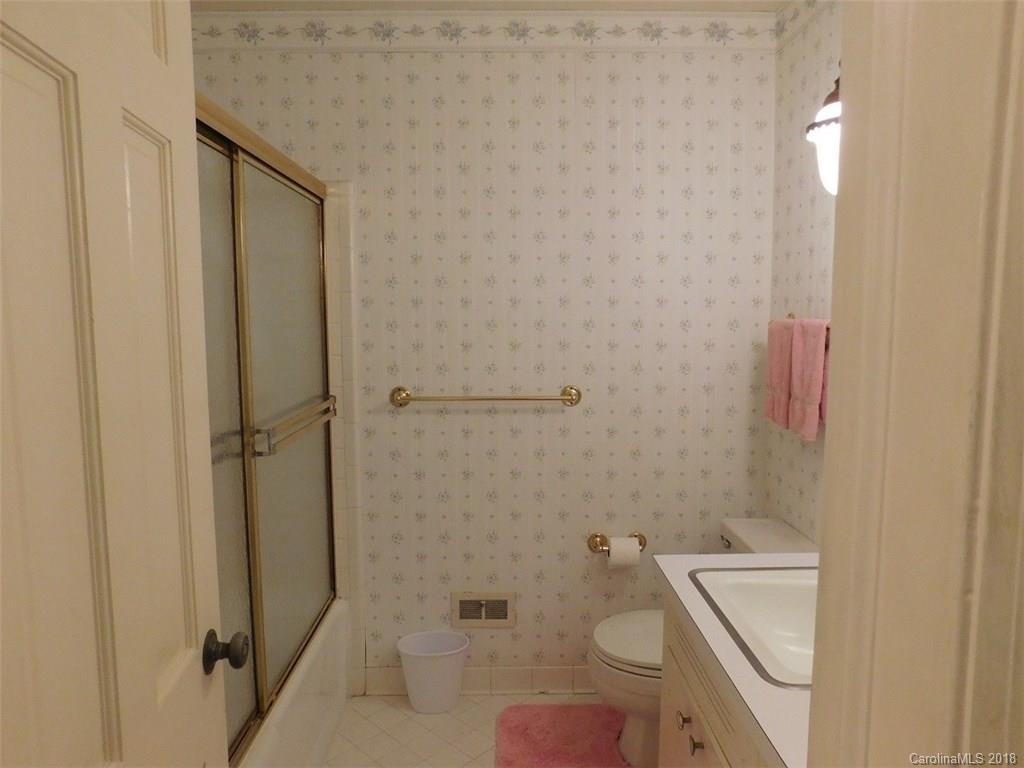 6311 Lake Forest Road East Charlotte, NC 28227 - Photo 24 of 31 a bathroom with a sink a toilet and shower
