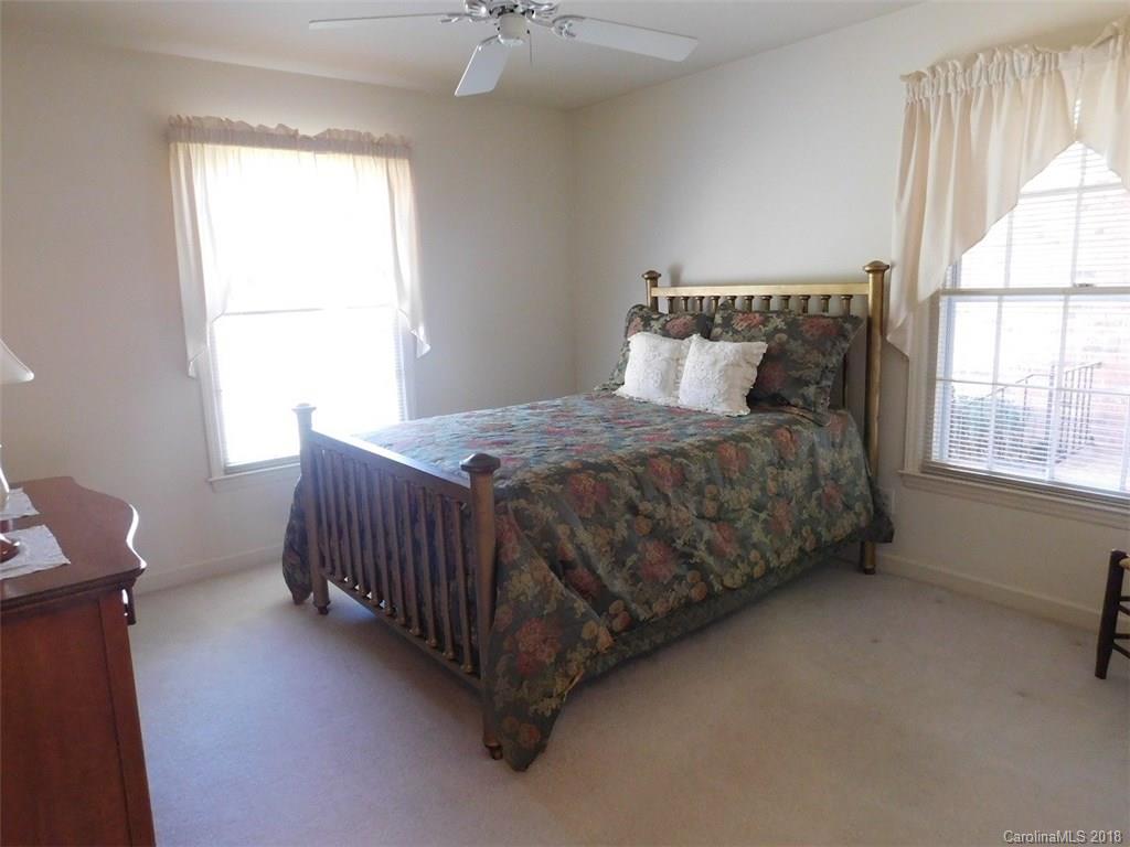 6311 Lake Forest Road East Charlotte, NC 28227 - Photo 25 of 31 a bedroom with a bed table and window