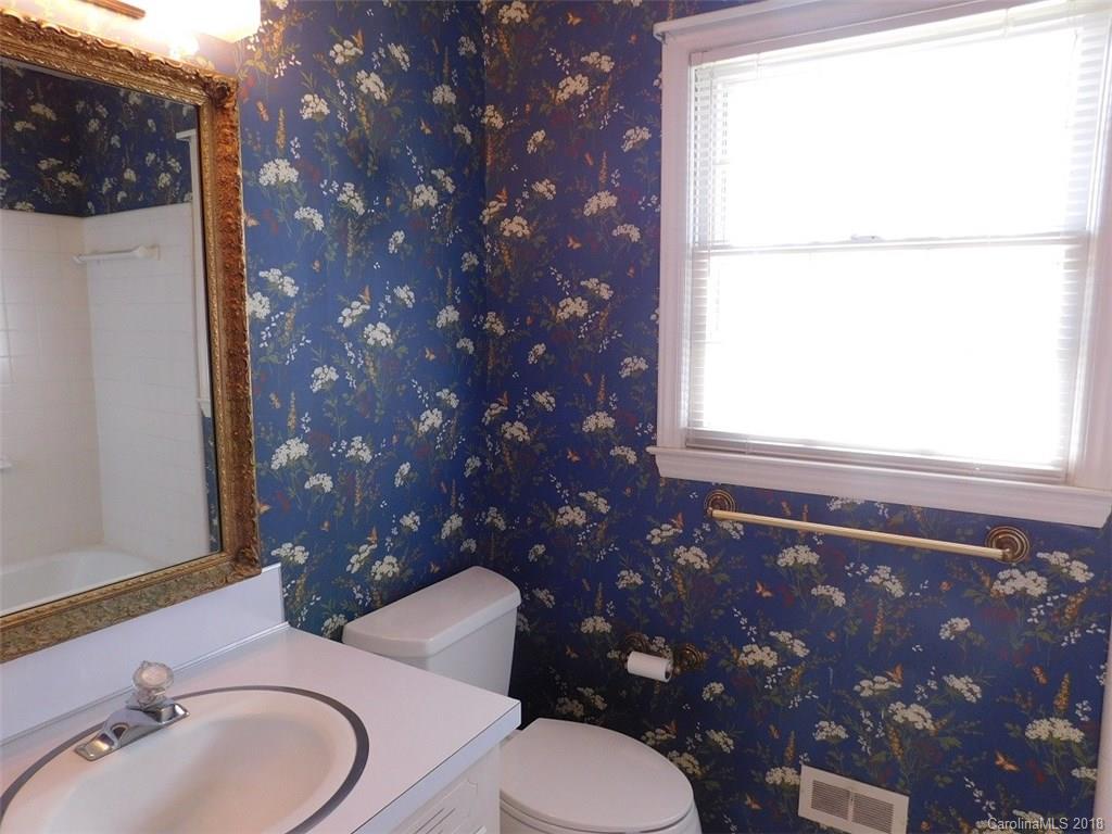 6311 Lake Forest Road East Charlotte, NC 28227 - Photo 26 of 31 a bathroom with a toilet sink and mirror