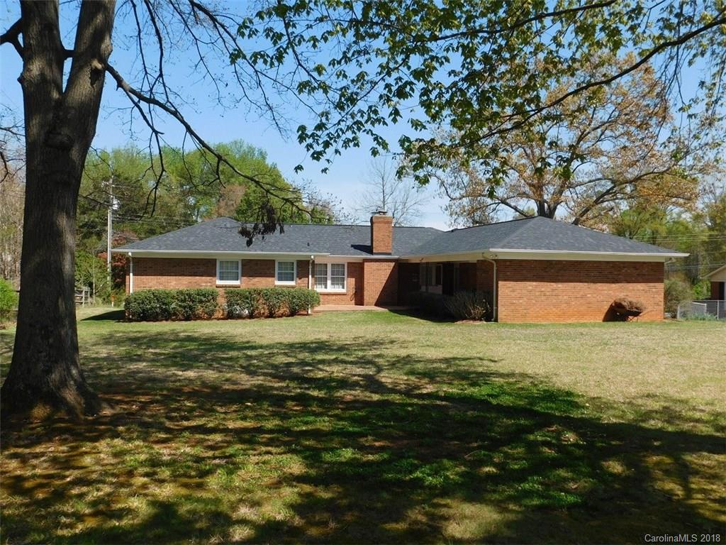 6311 Lake Forest Road East Charlotte, NC 28227 - Photo 28 of 31 a front view of house with yard and trees in the background